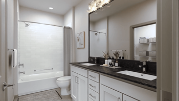 a bathroom with a large mirror and a toilet and a shower